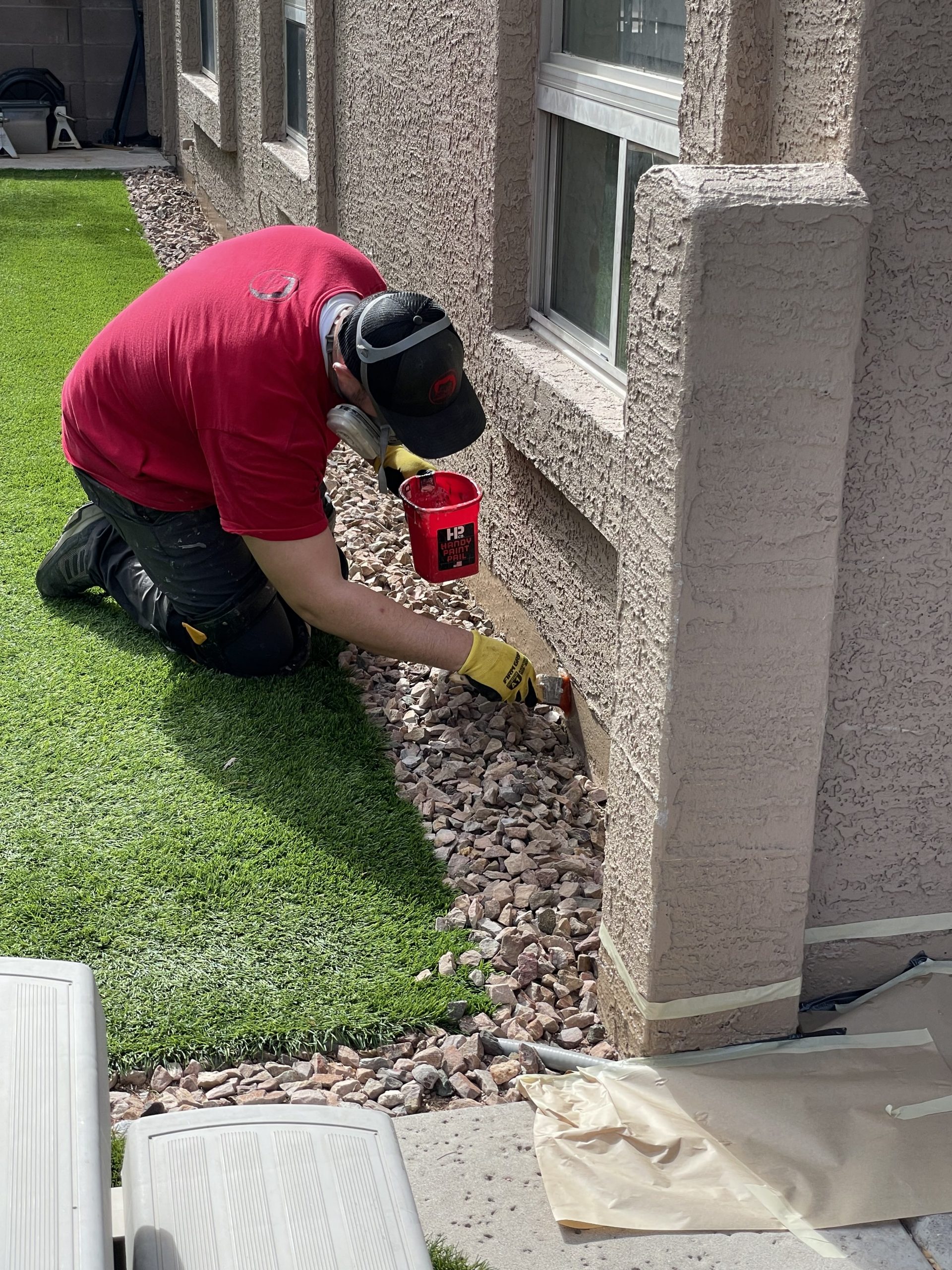 Technician applying Scorpion Repel to the exterior of a home.